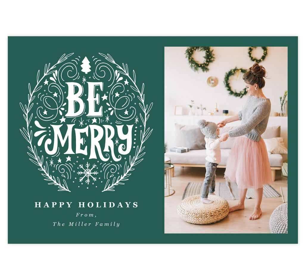 Be Merry Holiday Card; Teal/Green background with drawn "Be Merry" design in white. 'Happy holidays' written under the be merry design and spot for photo on the right.