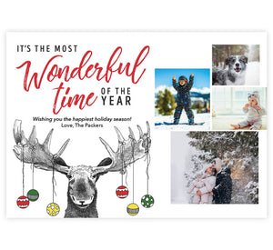 Christmas Moose Holiday Card; White background four photo spots on the right side and "It's the most wonderful time of the year" on the left side above a hand drawn moose with ornaments hanging off the antlers.