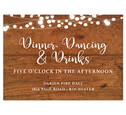 Rustic Glow wedding reception card; brown wood grain background with string lights on the top edge and white text
