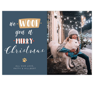 Woof Holiday Card; Dark, muted blue background with white text, a tan paw print and one photo spot.